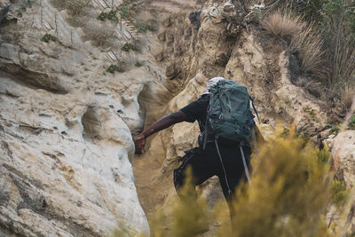 Rear view of person on rock formation at mount longonot, kenya 