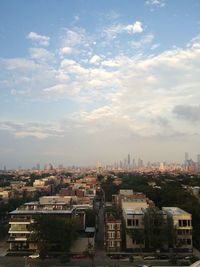 Cityscape against cloudy sky