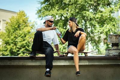 Couple sitting at skateboard park