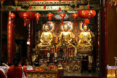 Statue of illuminated building in temple