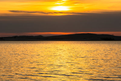 Scenic view of sea against romantic sky at sunset