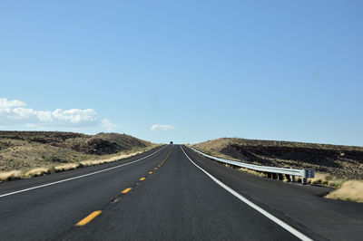 Empty road along countryside landscape