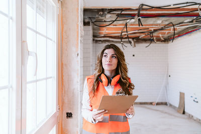 Inspector or architect professional woman checking kitchen at construction site. home improvement