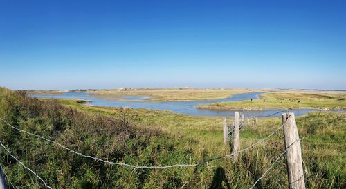 Scenic view of landscape against clear blue sky