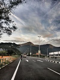 Cars on road against sky