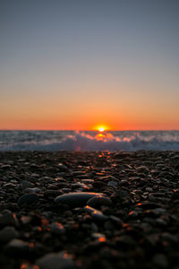 Close-up of sea against sky during sunset