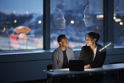 Two young business people working together in office