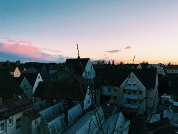 High angle view of buildings in town against sky at sunset