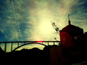 Silhouette of building against cloudy sky