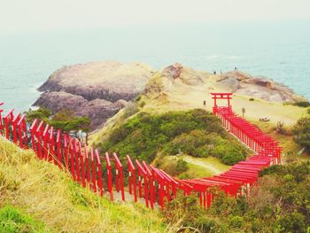 High angle view of landscape and sea against clear sky