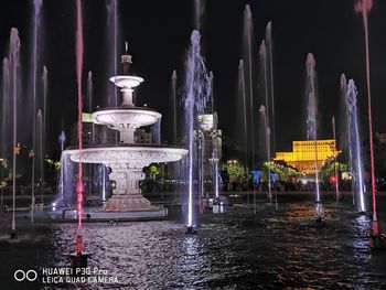 Illuminated fountain building at night