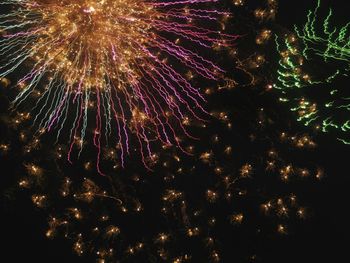 Low angle view of firework display at night