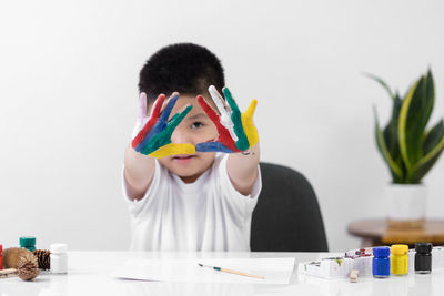 Portrait of boy looking at camera on table