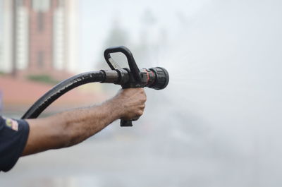 Close-up of man holding metal