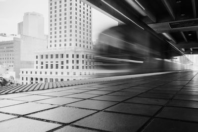 Blurred motion of train against buildings in city