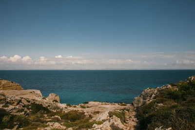 Scenic view of sea against blue sky