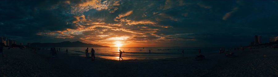 Panoramic view of beach against sky during sunset