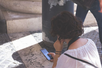 Rear view of woman using mobile phone