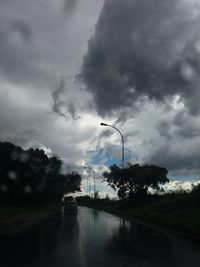 View of street against cloudy sky