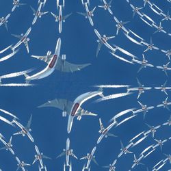 Low angle view of airplane flying against clear blue sky