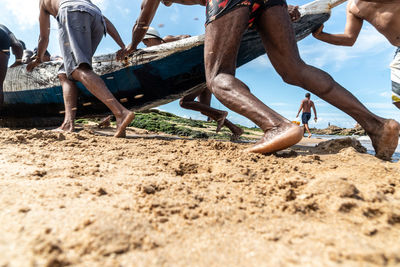 Fishermen removing their canoe from the sea to place in the boca do rio fishermen colony.