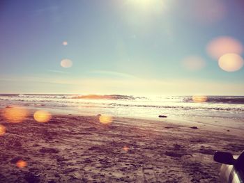 Scenic view of beach against sky during sunset