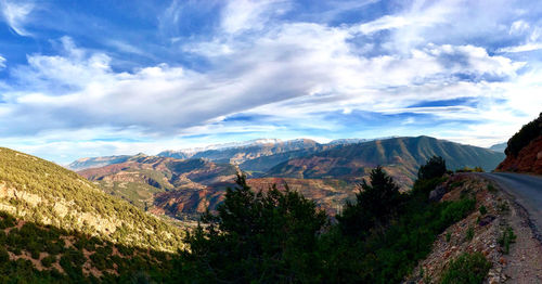 Scenic view of mountains against cloudy sky