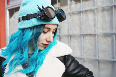 Close-up of fashionable woman with dyed blue hair in city