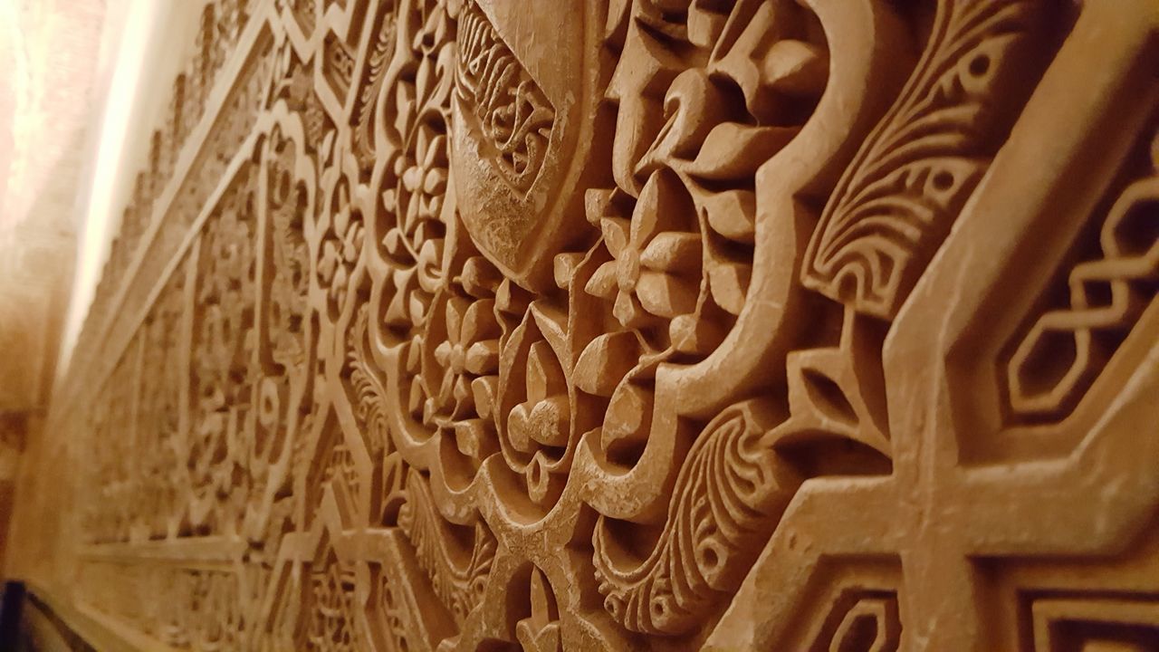 FULL FRAME SHOT OF CARVINGS ON WALL