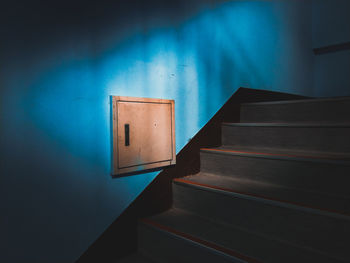 Empty blue wooden table against wall at home