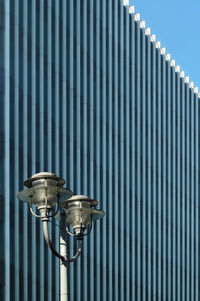 Street light against corrugated iron in city