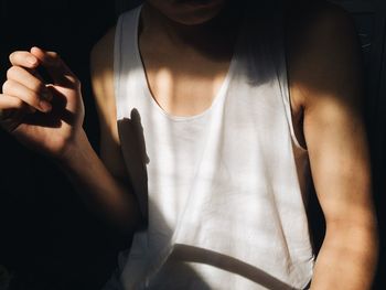 Midsection of man wearing tank top 