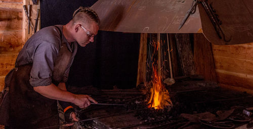 Side view of a man preparing food