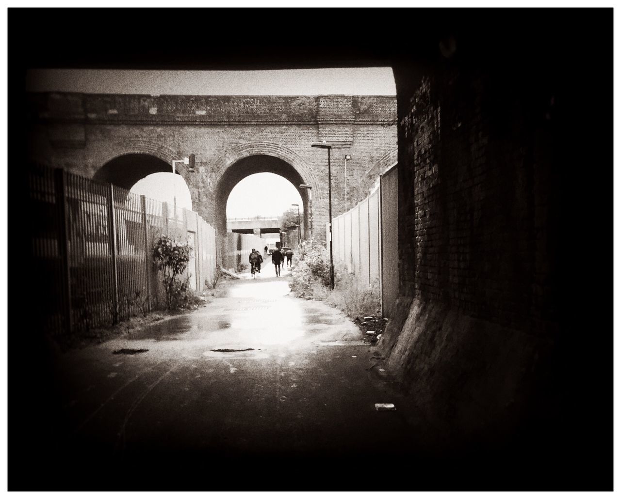 arch, transfer print, the way forward, architecture, walking, tunnel, men, built structure, indoors, full length, auto post production filter, rear view, transportation, diminishing perspective, lifestyles, archway, person, road