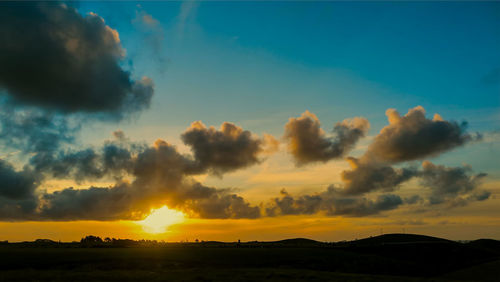 Scenic view of dramatic sky during sunset