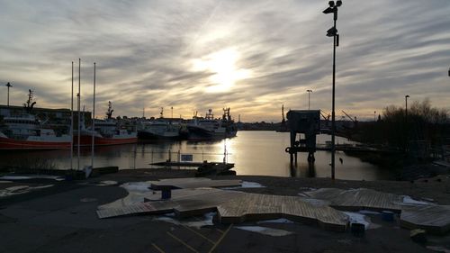 Boats in harbor at sunset