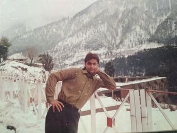 Portrait of young man standing in snow