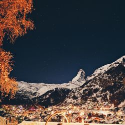 Scenic view of snowcapped mountains against sky at night