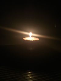 Close-up of illuminated light against sky at night