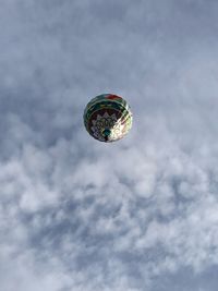 Low angle view of crystal ball against sky