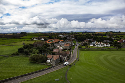 Houses on field against sky