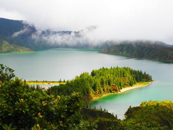 Scenic view of lake and mountains against sky