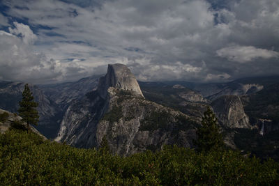 Scenic view of mountains against cloudy sky