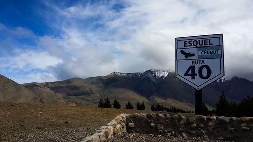 Information sign on landscape against sky