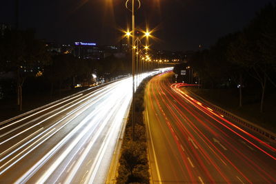High angle view of light trails on highway at night