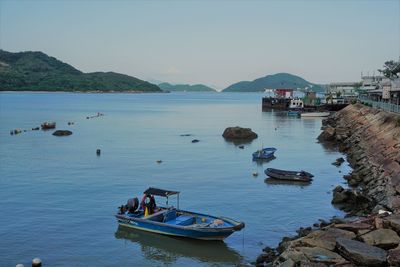 Boats in sea against clear sky