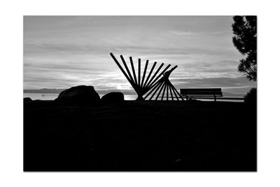 Silhouette people on beach against sky at dusk