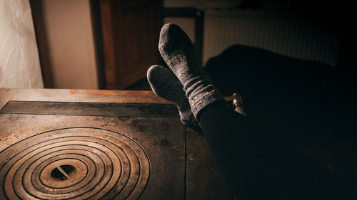 Low section of person by window at home