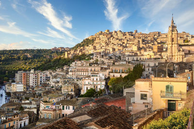 Buildings in town against sky