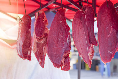 Close-up of red leaves hanging at market stall